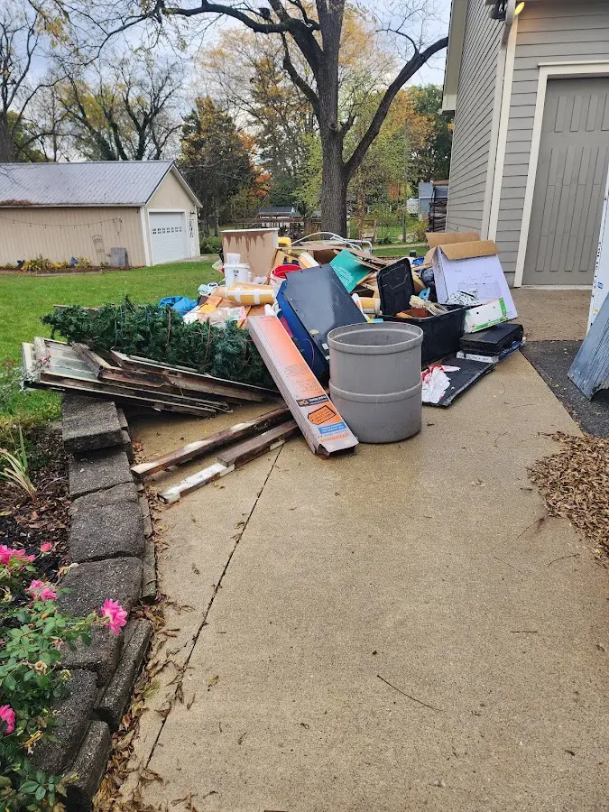 Dumpster being loaded with debris for Estate Cleanout Dumpster Rental in Coal City